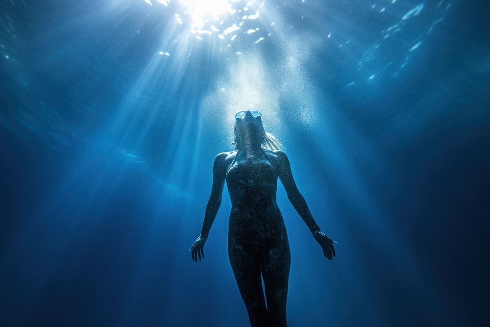 Woman freediving underwater adventure swimming. 