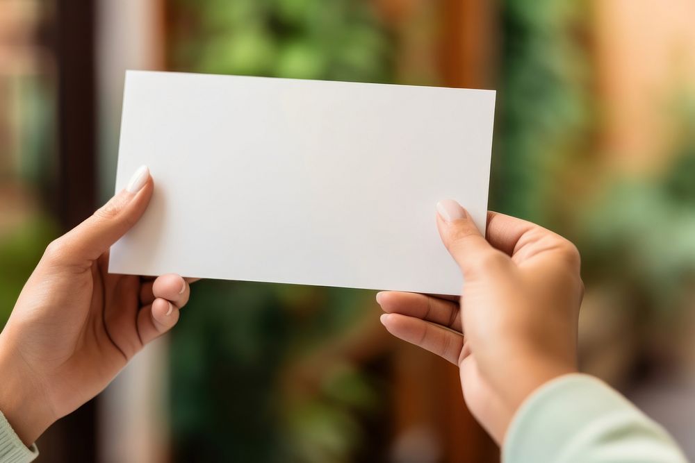 White card holding paper hand. 