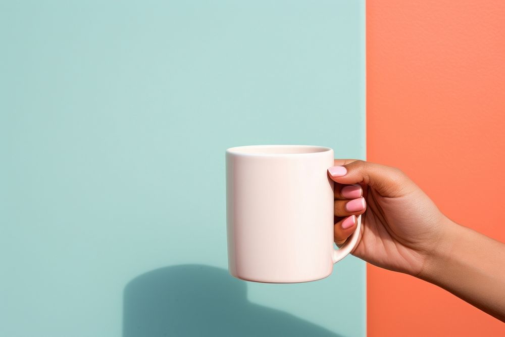 Coffee mug holding drink hand. 