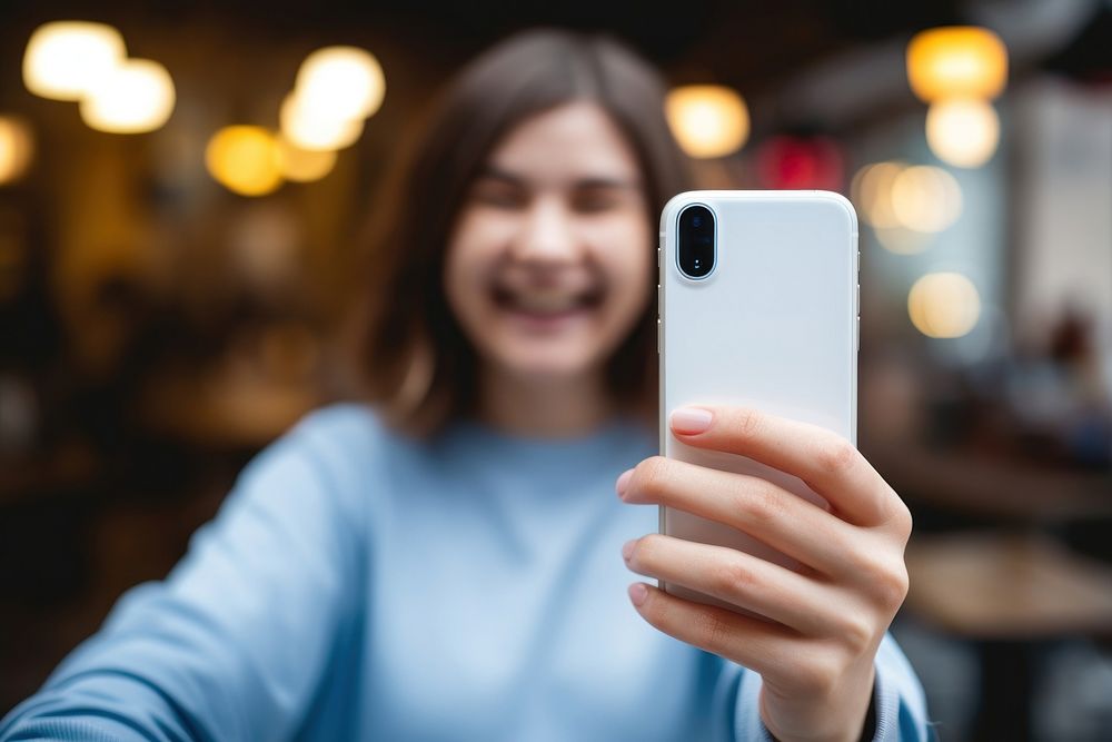 White smartphone holding selfie adult. 