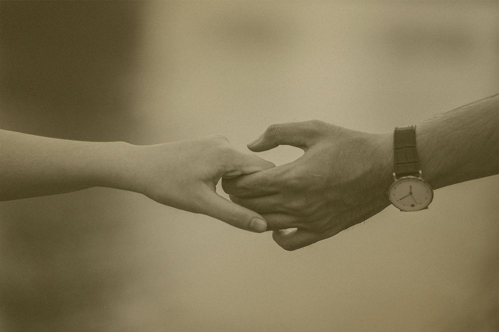 Hands holding with sepia effect