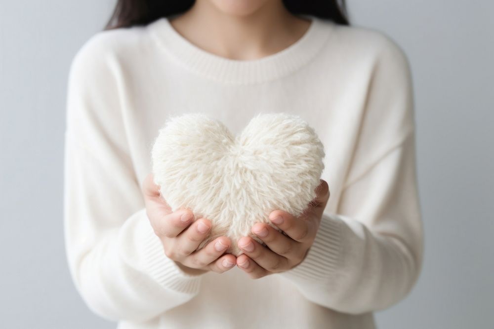 People hold heart sweater white love. AI generated Image by rawpixel.