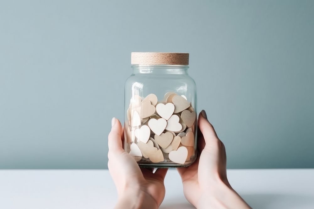 Hands giving hearts jar pill investment. AI generated Image by rawpixel.
