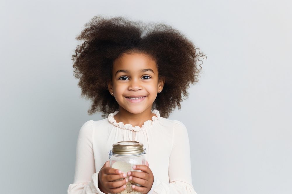 Little girl donations smile white background hairstyle. AI generated Image by rawpixel.
