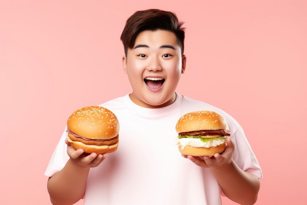Chinese teenage guy hamburger holding eating. AI generated Image by rawpixel.