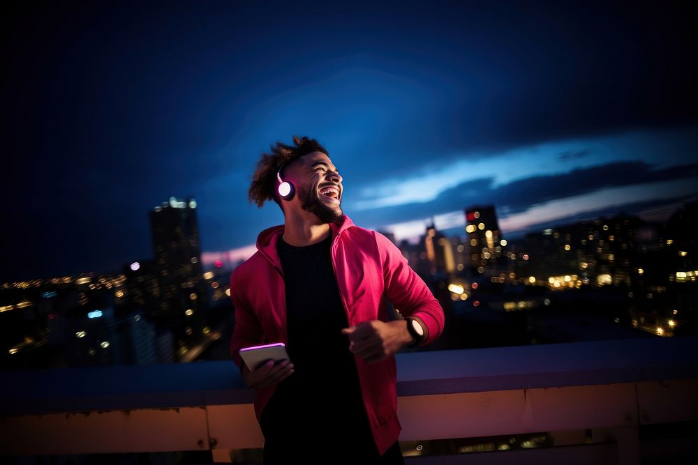 Hispanic man wear neon earphone city outdoors night. AI generated Image by rawpixel.