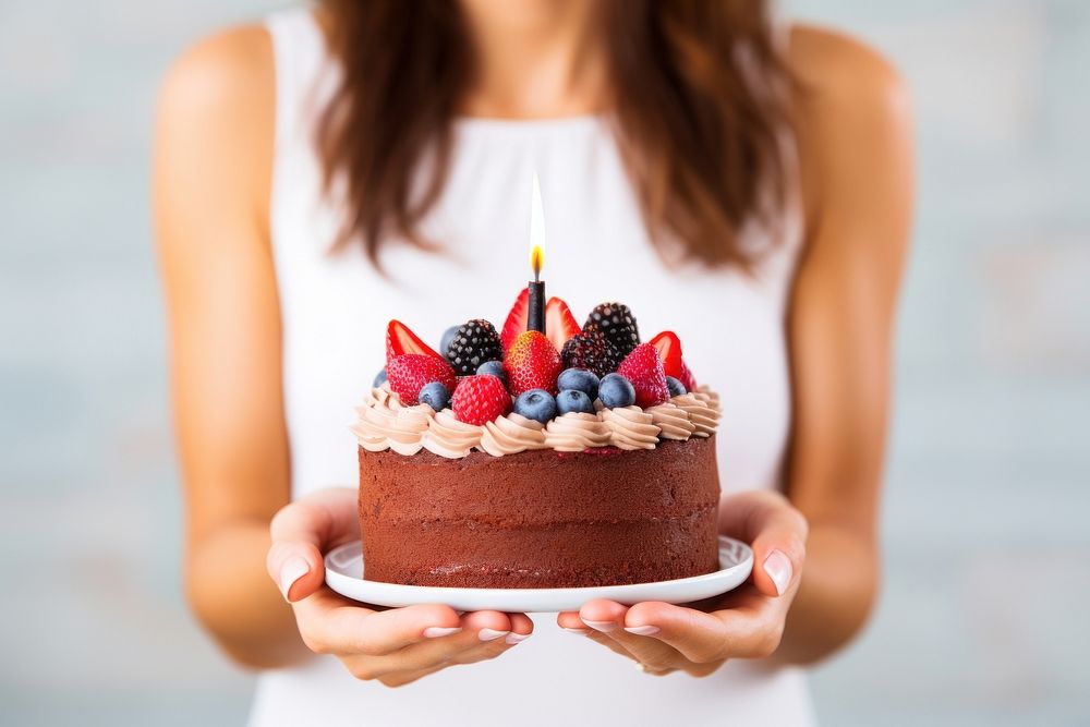 Birthday cake dessert holding berry. AI generated Image by rawpixel.