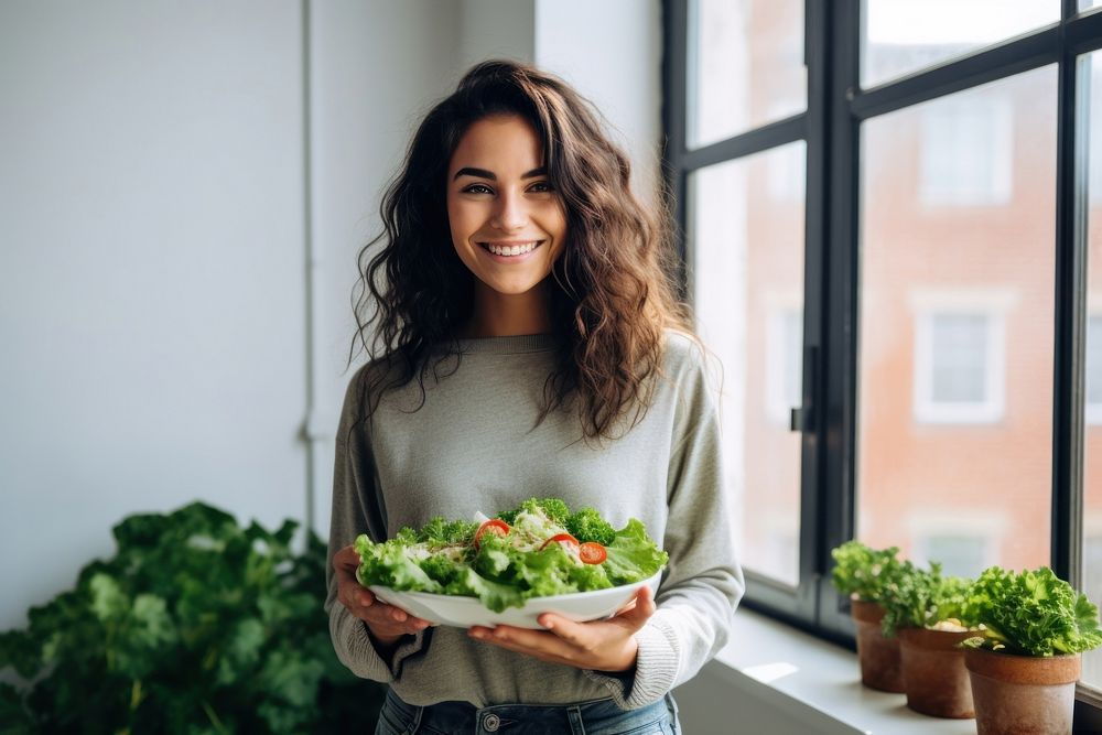 Happy Young woman holding salad smile adult plant. 