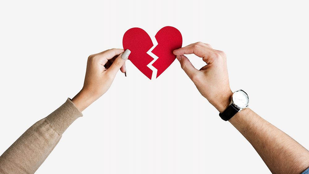 Hands holding broken heart, isolated image
