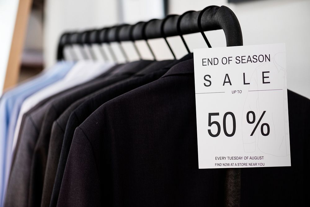 A hanging clothes with sale sign