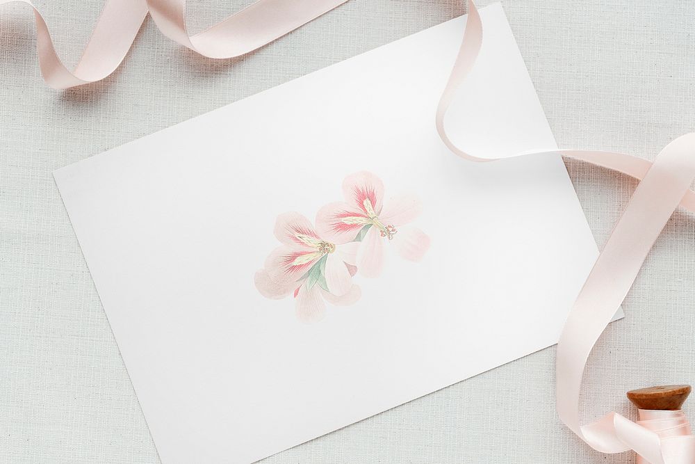 Floral card template mockup with a pink ribbon roll
