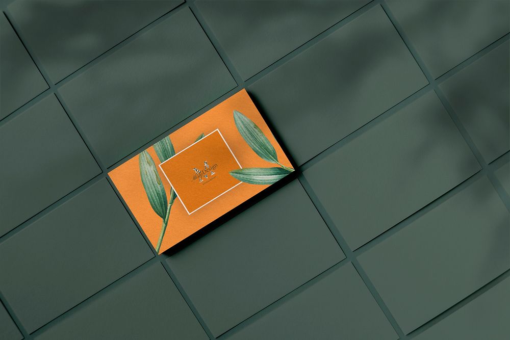 Orange business card with botanical design