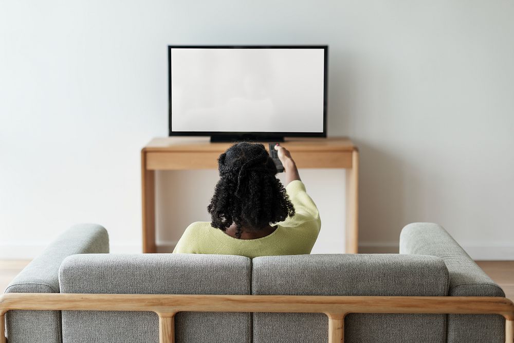 Woman watching TV in her living room 