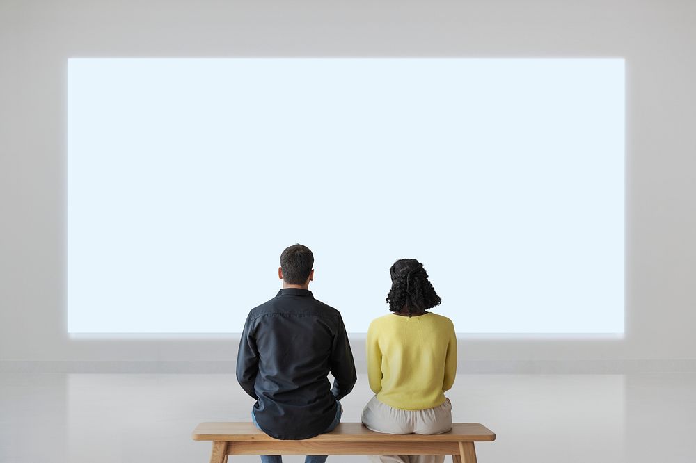 Couple with projector wall mockup psd rear view