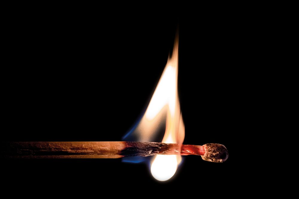 Lit matchstick, isolated image