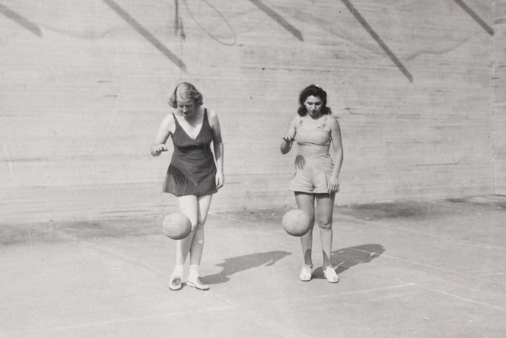  Two Women Dribbling Basketballs