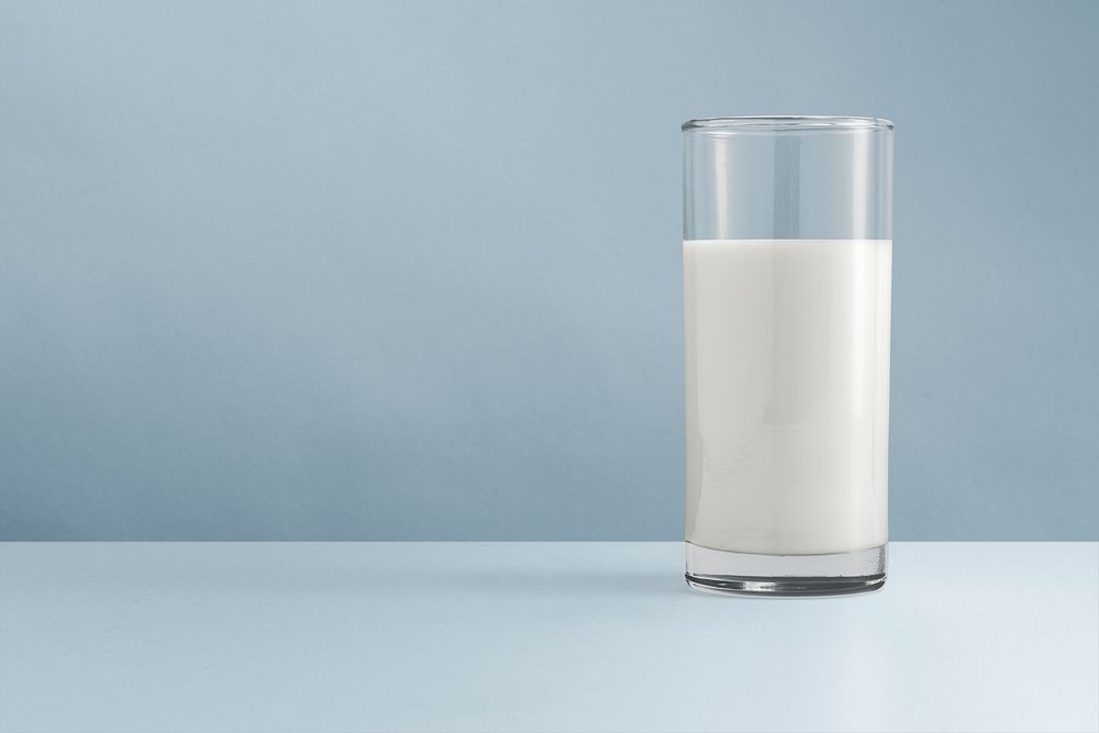 Glass of milk, blue background