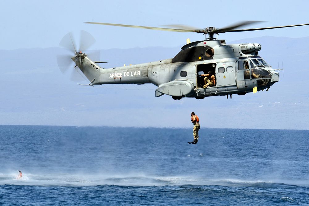 A U.S. Airman assigned to the 82nd Expeditionary Rescue Squadron jumps from a French SA-330 Puma helicopter into the Gulf of…