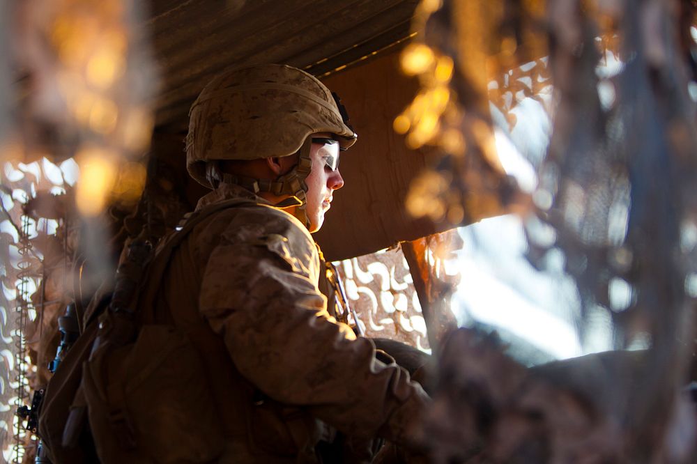 A U.S. Marine with the 3rd Battalion, 7th Marine Regiment stands guard at Observation Post Athens in Helmand province…