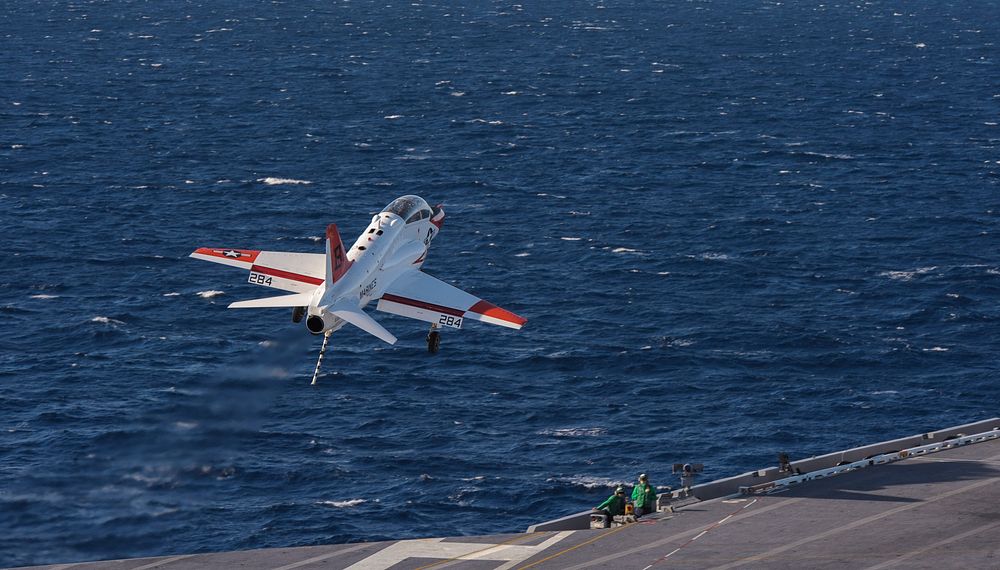A U.S. Navy T-45C Goshawk aircraft assigned to Training Air Wing (TW) 2 performs a touch-and-go landing aboard the aircraft…