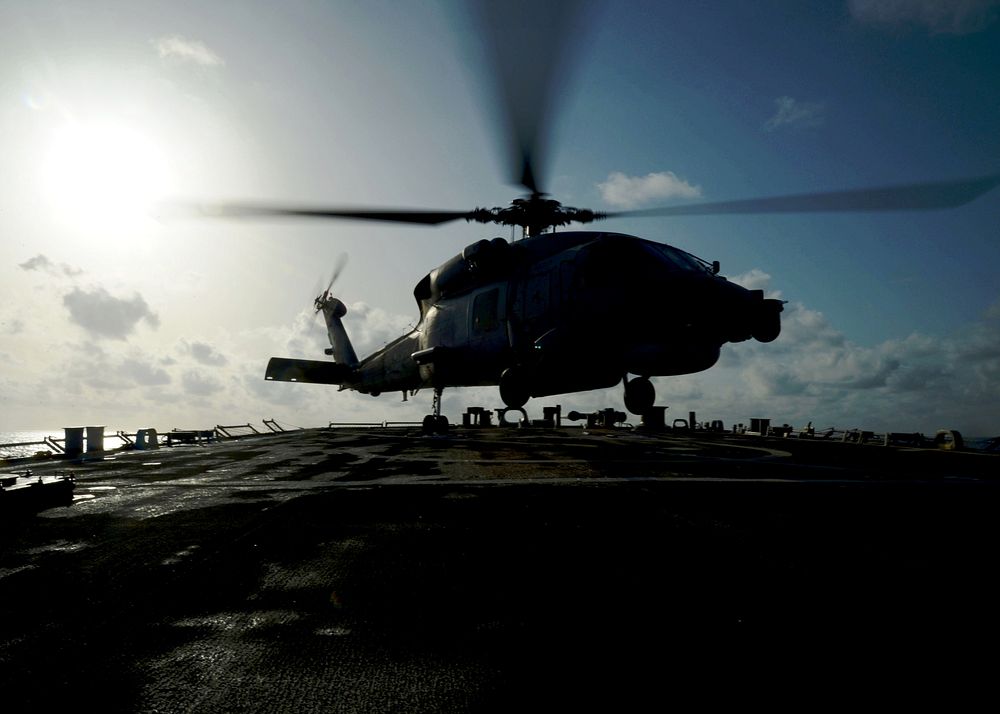 A Greek navy MH-60R Seahawk helicopter assigned to the Greek frigate HS Salamis (F 455) prepares to land on the flight deck…