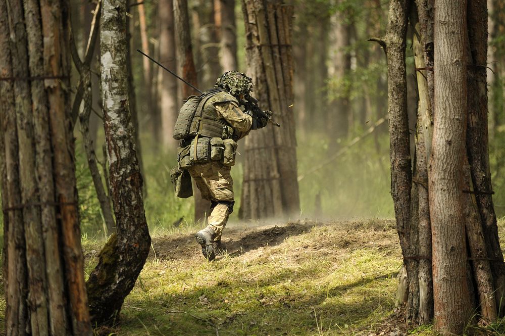 A Danish soldier rushes an objective during a live-fire exercise at the Joint Multinational Training Command's Grafenwoehr…