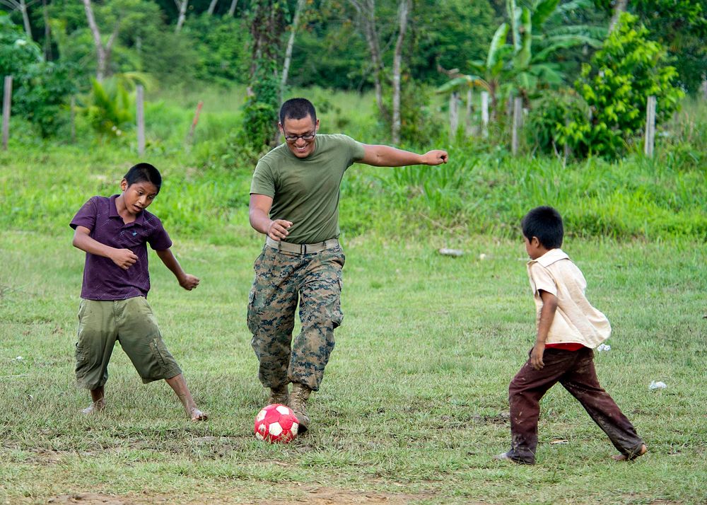U.S. Marine Corps Lance Cpl. Esgar A. Castro plays soccer with students at Bethel Seventh-day Adventist School in Punta…