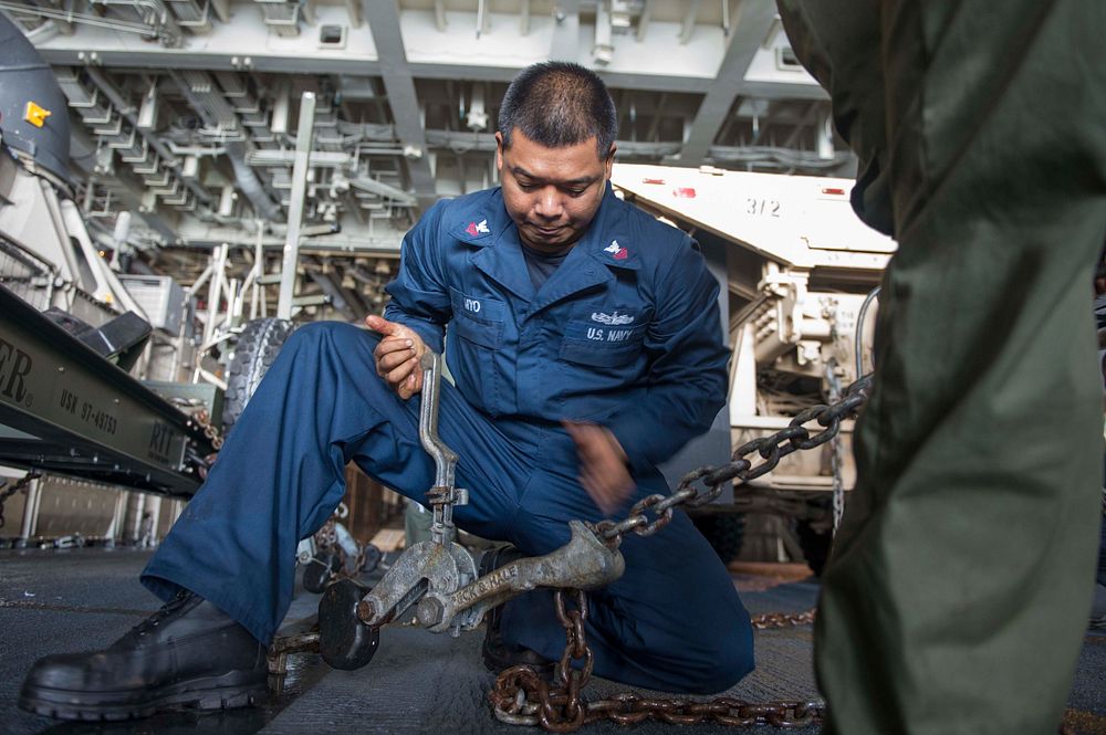U.S. Navy Gas Turbine Systems Technician (Mechanical) 1st Class Arthur S. Myo, assigned to Assault Craft Unit 5, secures a…