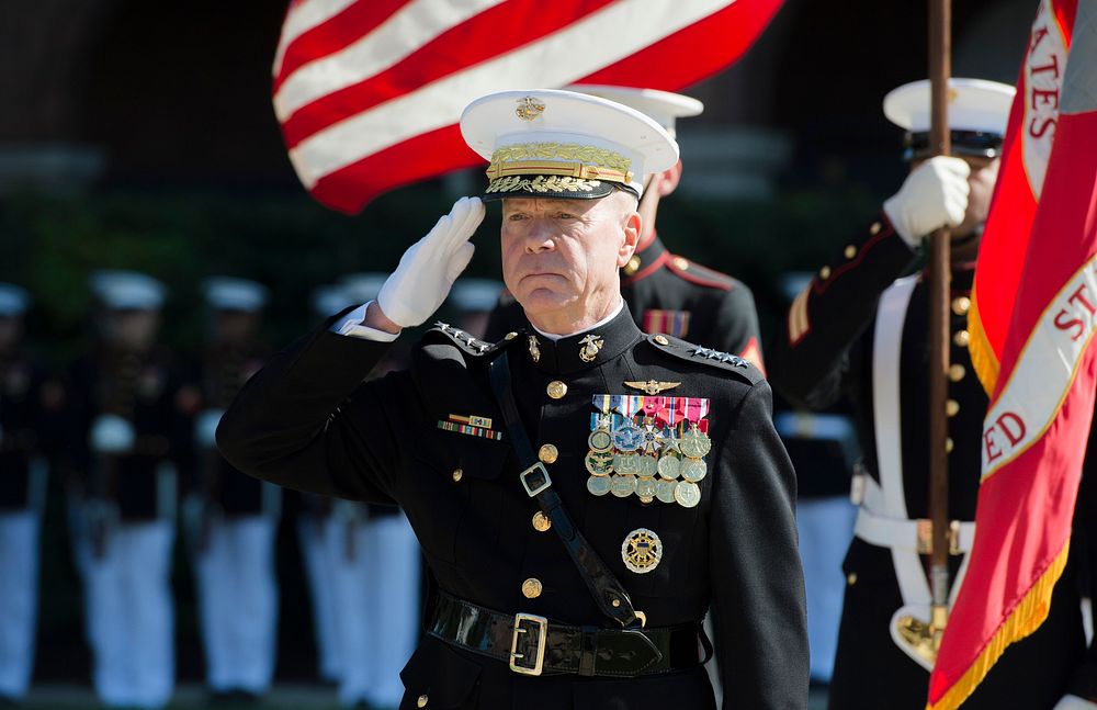 U.S. Marine Corps Gen. James F. Amos, the outgoing commandant of the Marine Corps, salutes during a change of command and…