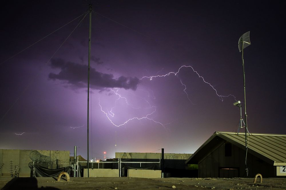 A dust storm carrying small amounts of rain sparks lightning across the sky over camps Leatherneck and Bastion in Helmand…