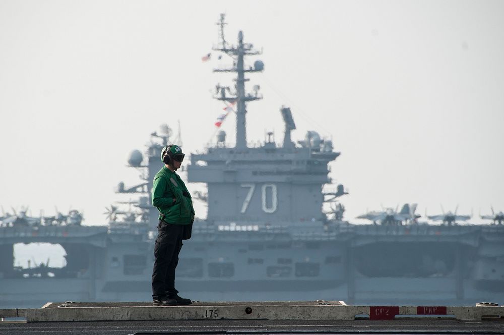 The aircraft carrier USS Carl Vinson (CVN 70), background, relieves the aircraft carrier USS George H.W. Bush (CVN 77) in…