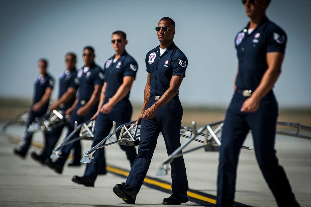 U.S. Air Force Staff Sgt. Benjamin Ayivorh, second from right, a crew chief with the Thunderbirds, performs the ground show…
