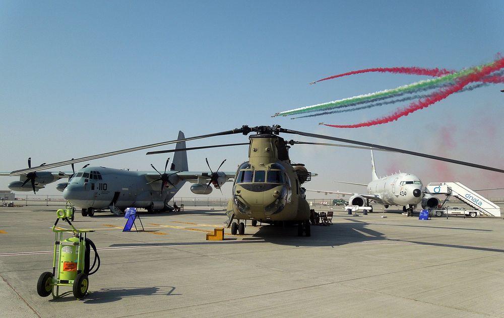The “Al Fursan” (The Knights), the United Arab Emirates Air Force aerobatic display team, perform behind a U.S. Marine Corps…