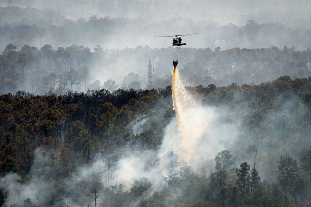 A Texas Army National Guard UH-60 Black Hawk out of the Austin Army Aviation Facility helps fight wildfires threatening…