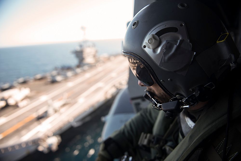 151202-N-MQ094-022 MEDITERRANEAN SEA (Dec. 2, 2015) A French aircrewman looks out of an NH-90 Caman helicopter as it departs…