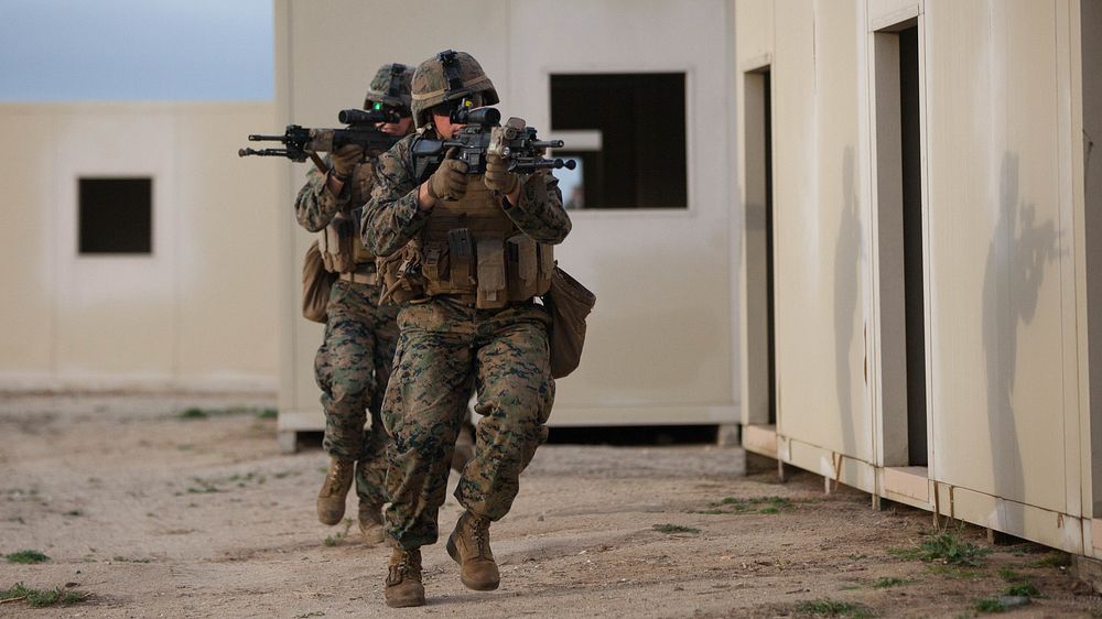 1st Battalion, 1st Marine Regiment infantrymen tactically move from building to building in a simulated combat zone during…