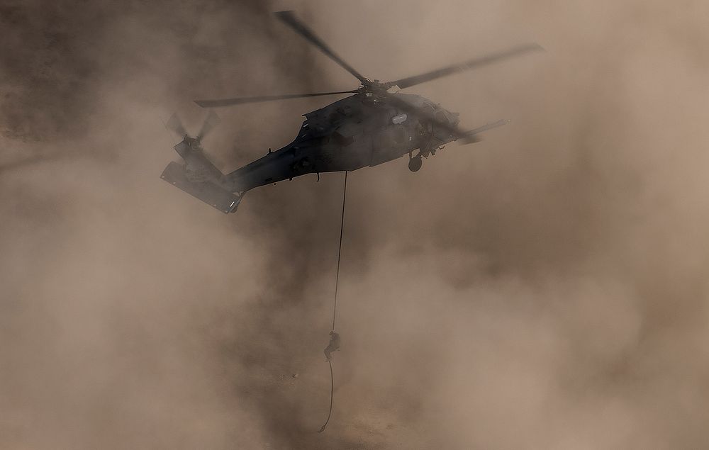 A pararescueman repels out of an HH-60G Pave Hawk helicopter, assigned to the 66th Rescue Squadron, during training on…