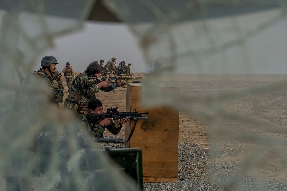 10th Special Operation Kandak Commandos conduct small arms barrier firing drills during a series of weapons proficiency…