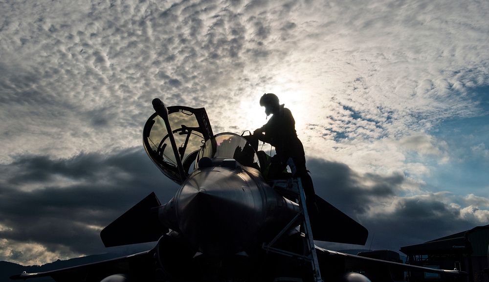 A French air force fighter pilot climbs out of a Dassault Rafale, a multirole fighter aircraft after participating in a…