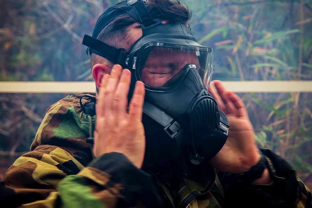 A U.S. Marine with the 26th Marine Expeditionary Unit equips his gas mask during a chemical, biological, radiological and…