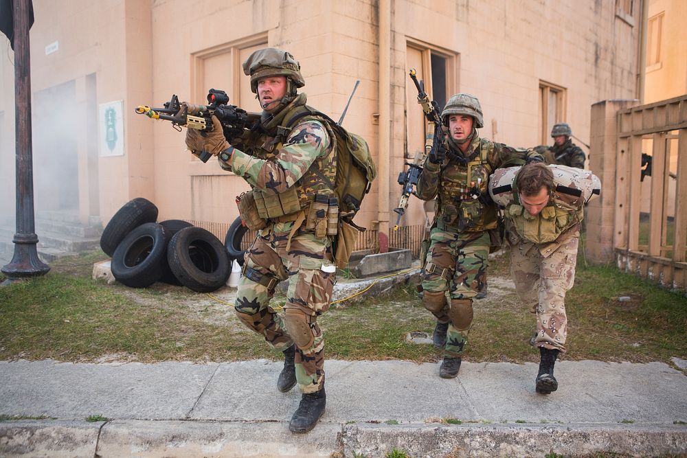 Royal Netherlands Marines move a role-playing captured insurgent during an urban training exercise involving U.S. Marines…