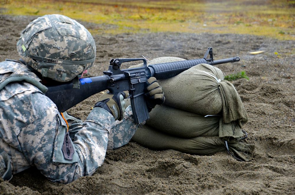 A U.S. Soldier assigned to the 42nd Military Police Brigade fires his issued M4 carbine rifle during the M4 qualification…