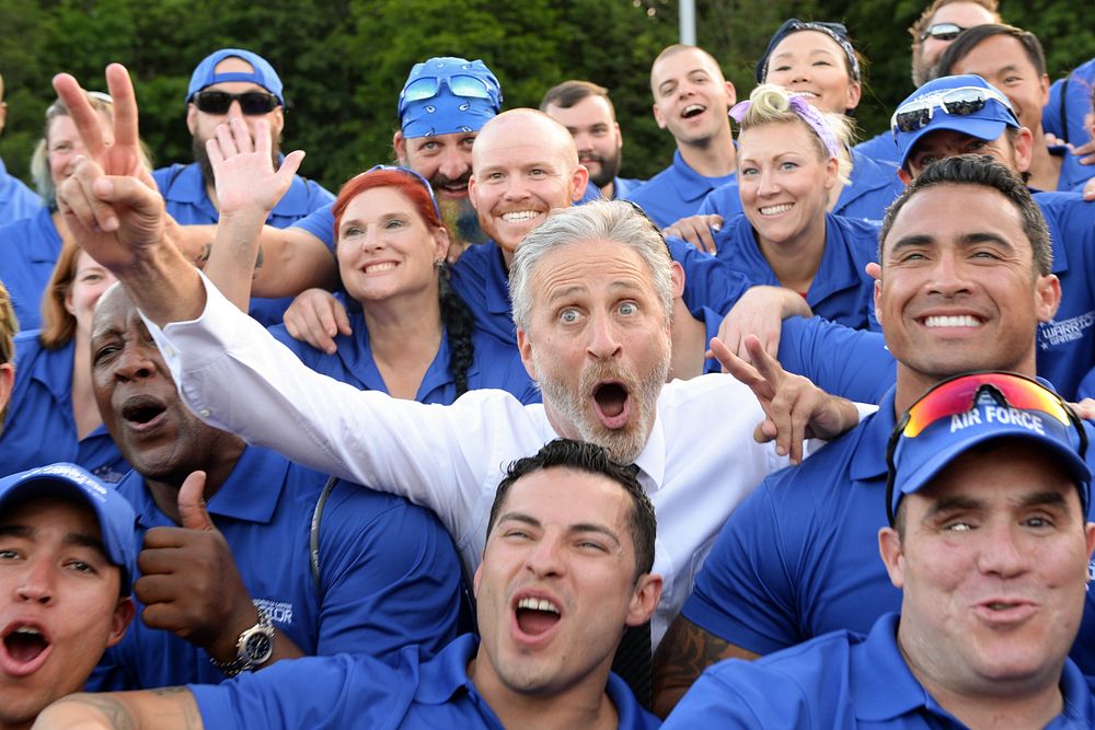 Television and movie personality Jon Stewart, most notably of The Daily Show, poses for a photo with the Air Force team for…