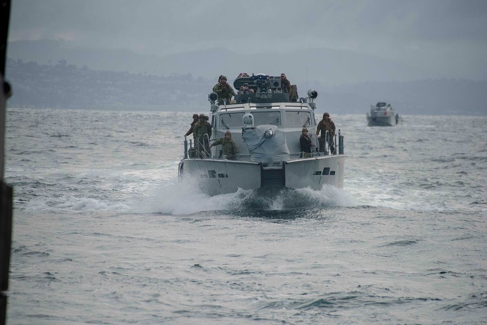 A Mark VI patrol boat assigned to Coastal Riverine Squadron (CRS) 3 prepares to enter the well deck of the amphibious…