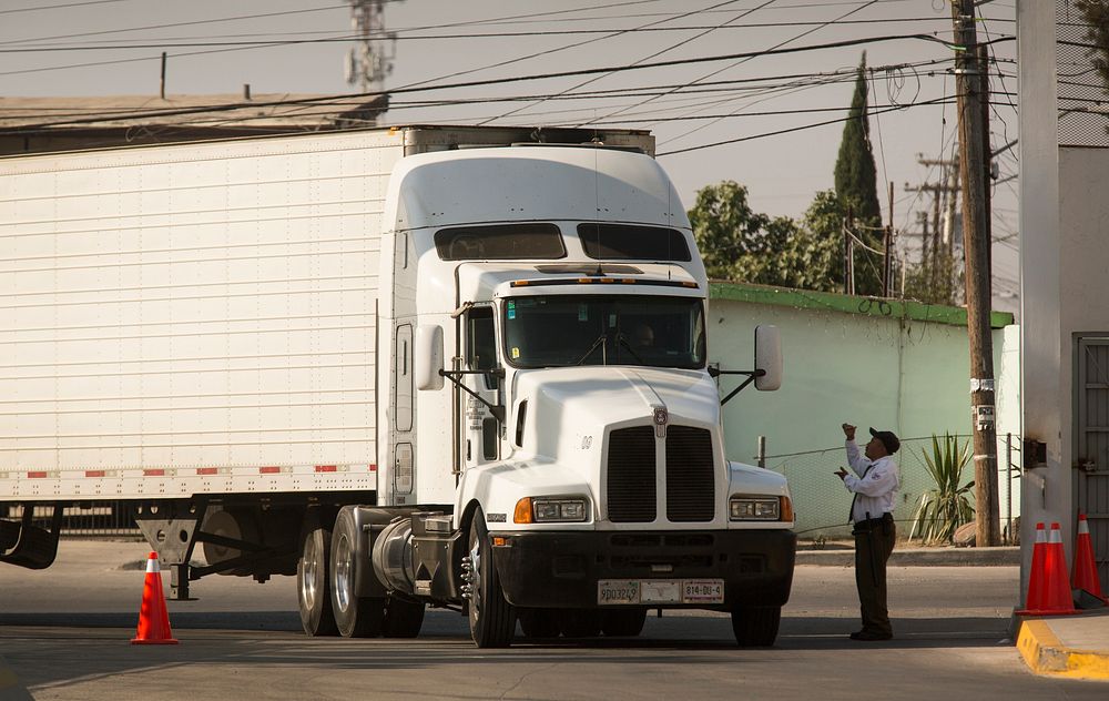 A truck is greeted by a Mexican security guard as it leaves Mesa de Otay, Mexico, and crosses into the Cargo Pre-Inspection…