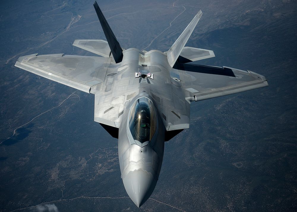 A U.S. Air Force F-22 Raptor aircraft assigned to Langley Air Force Base transits after refueling from a KC-135 Stratotanker…