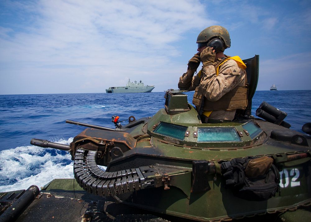 Cpl. Ryan Dills communicates with other assault amphibious vehicles while traveling from amphibious assault ship USS San…
