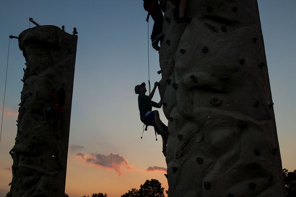 A child climbs a rock wall during the 33rd annual National Night Out at the McGlachlin Parade Field on Fort Meade, Md., Aug.…