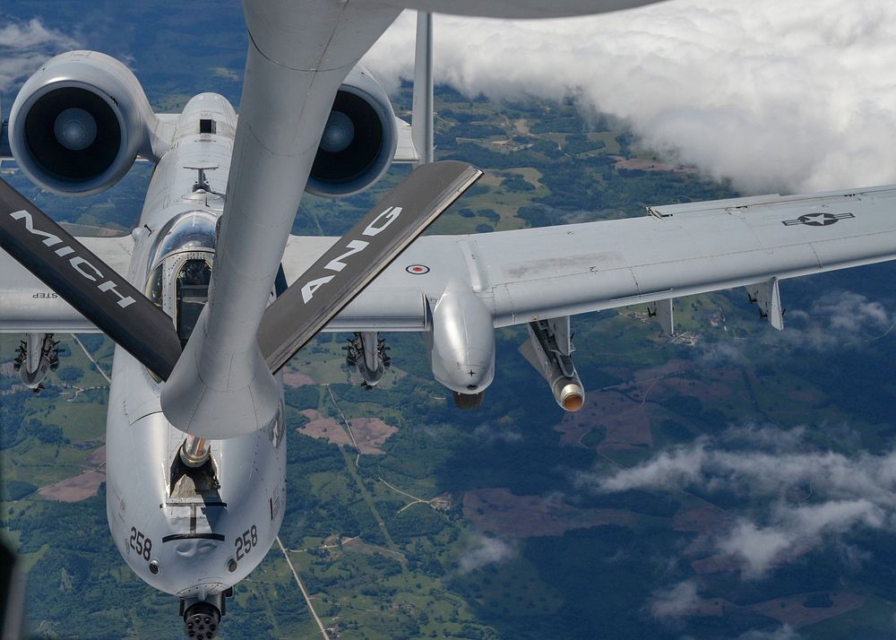 A U.S. Air Force KC-135 Stratotanker refuels an A-10 Thunderbolt II during flight while partaking in Saber Strike 18 over…