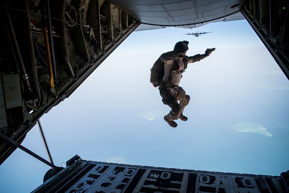 A U.S. Air Force combat rescue officer assigned to the 82nd Expeditionary Rescue Squadron, exits the back of a C-130J Super…